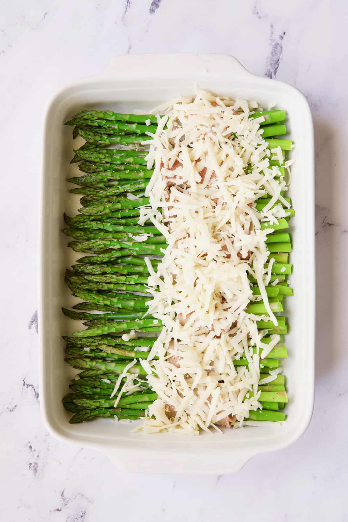 Photo of asparagus covered with Gruyere cheese.