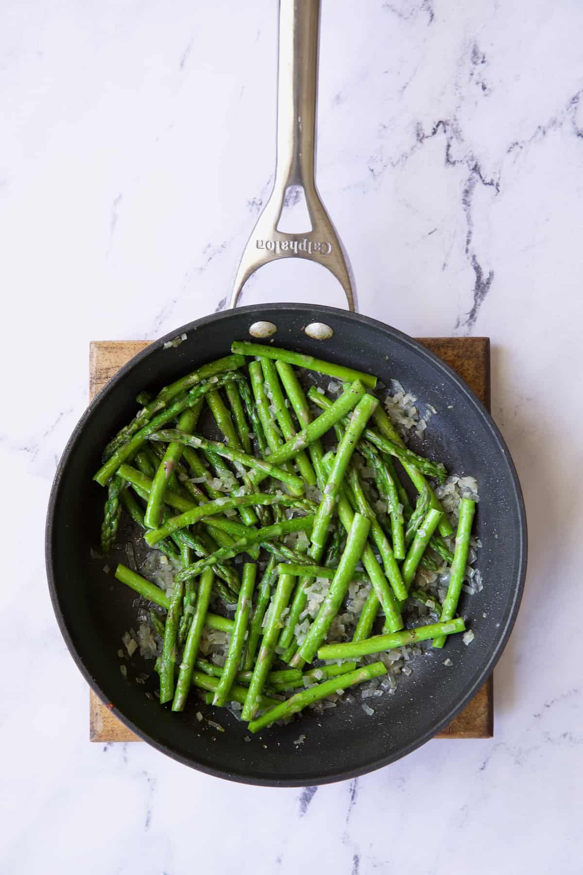 Photo of sauteed asparagus in nonstick skillet.