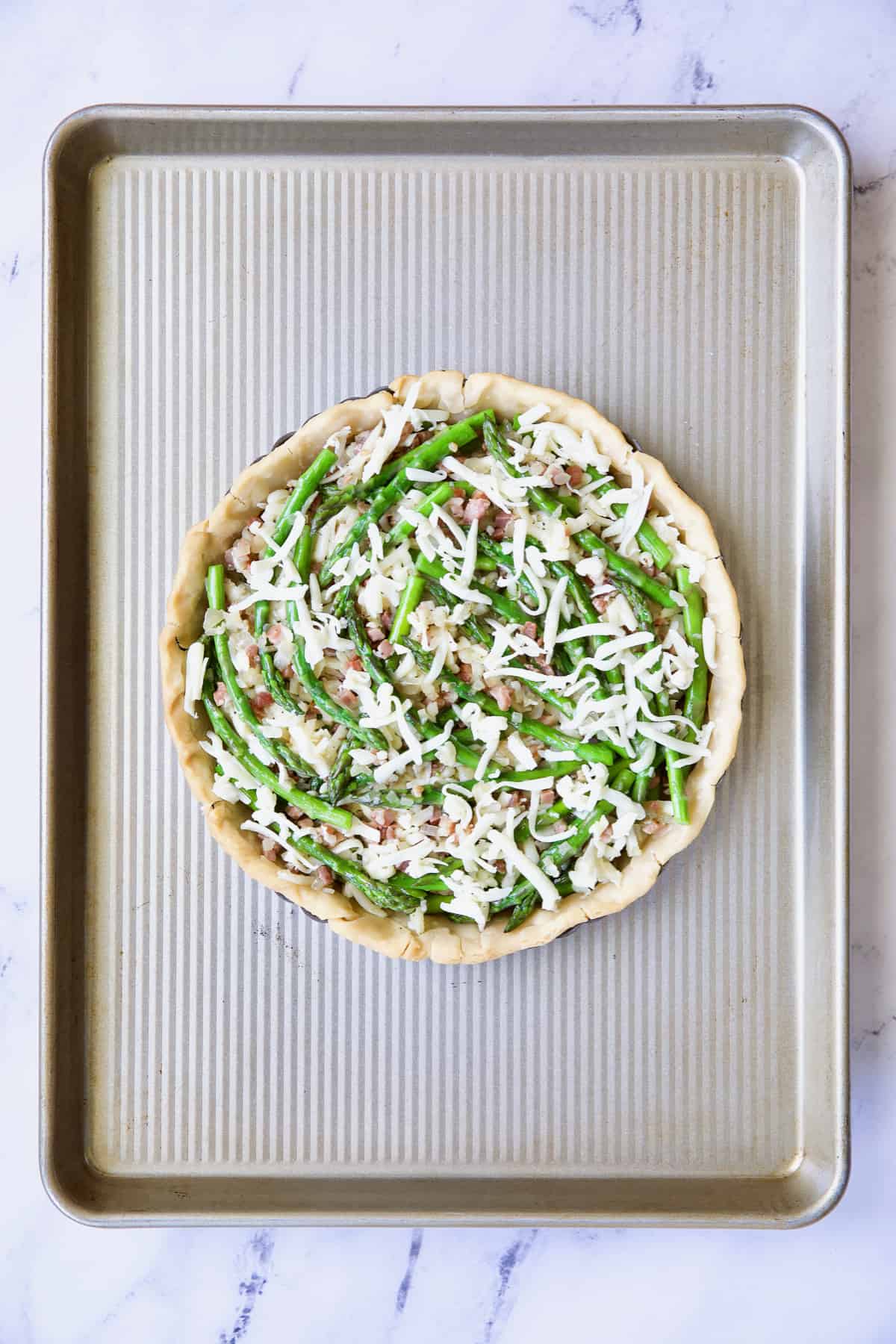 Photo of Asparagus Prosciutto and Fontina Tart on baking sheet before custard is added.
