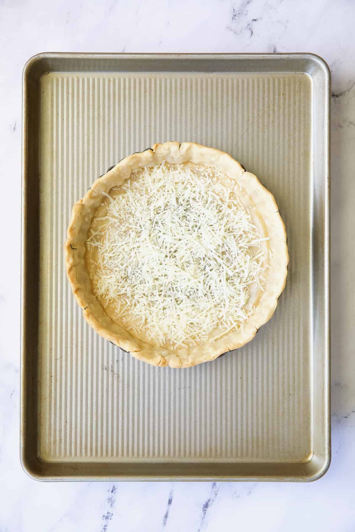 Photo of baked pie crust on baking sheet.