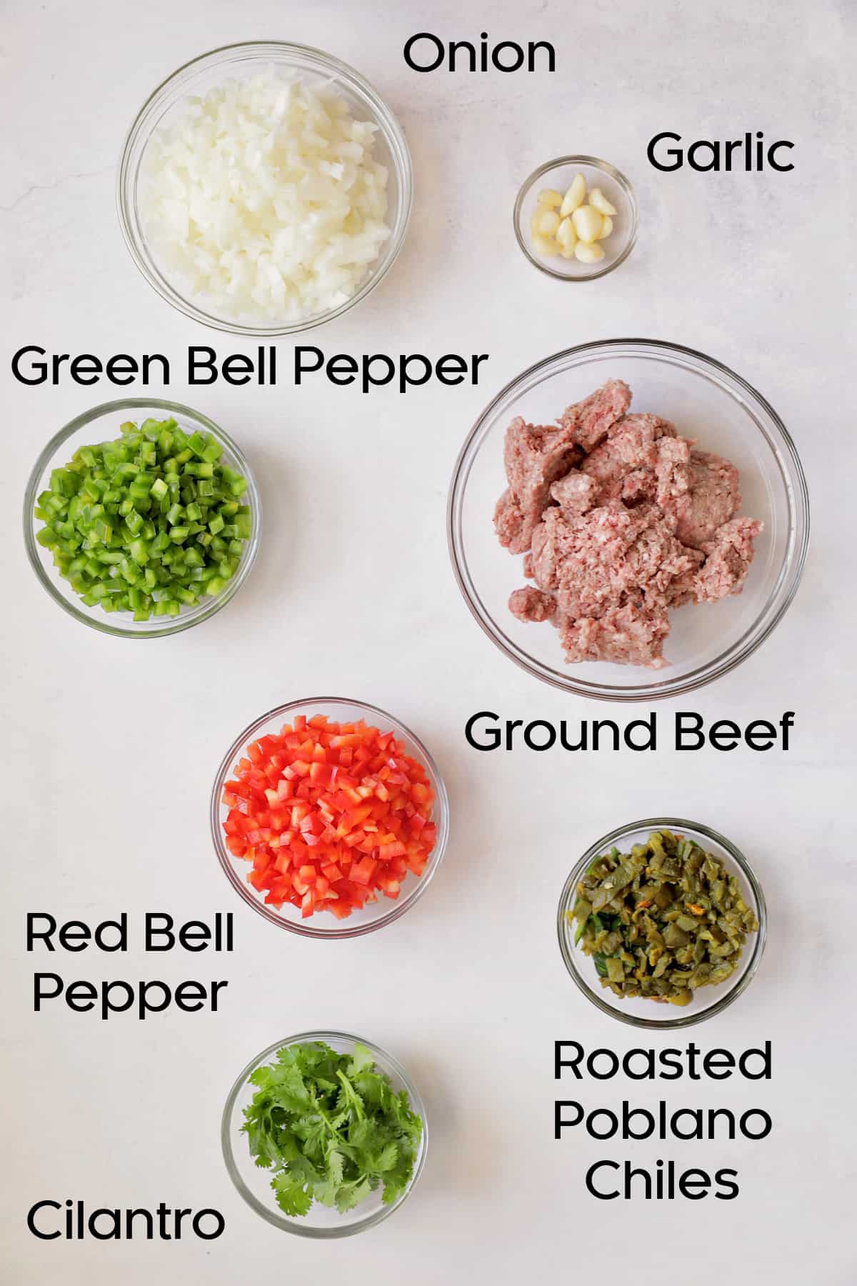 Photo of fresh ingredients for Southwestern Stuffed Pepper Soup in glass bowls.
