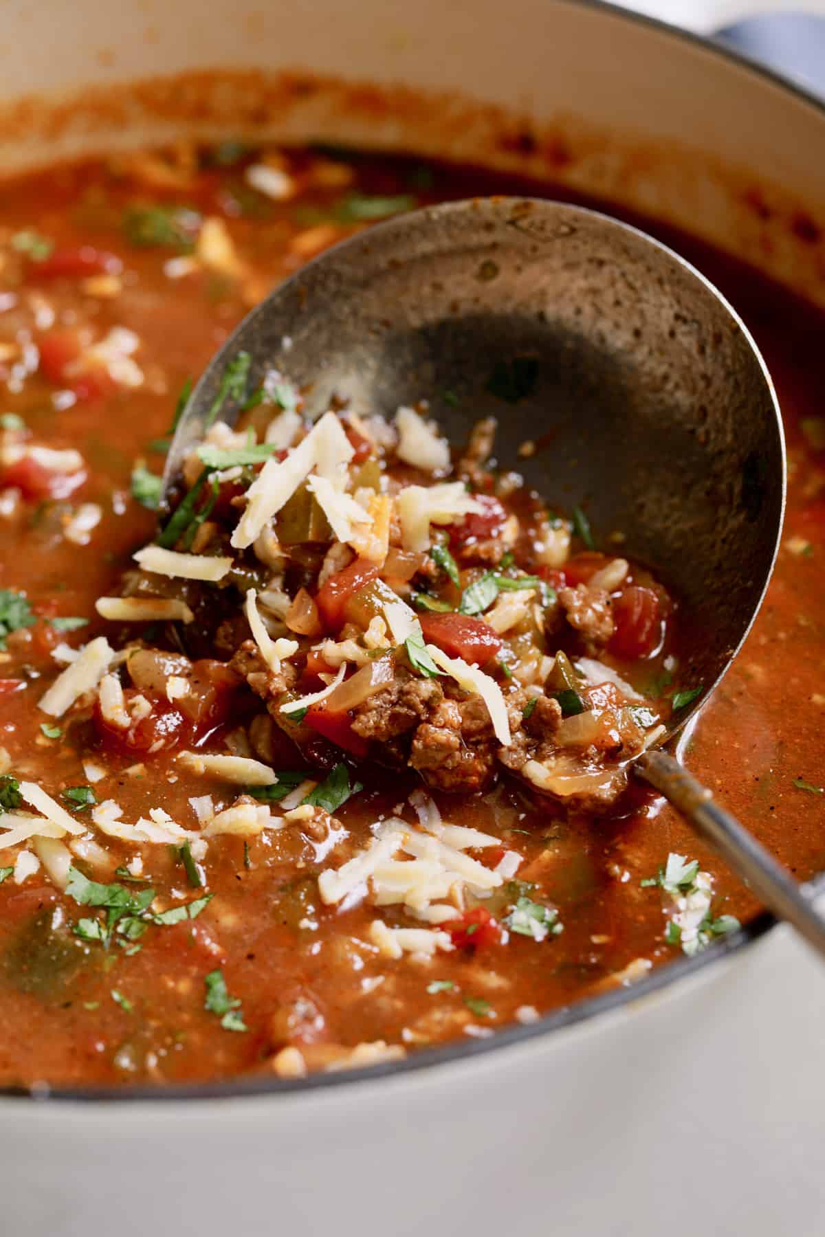 Close-up photo of a ladle scooping up Southwestern Stuffed Pepper Soup.