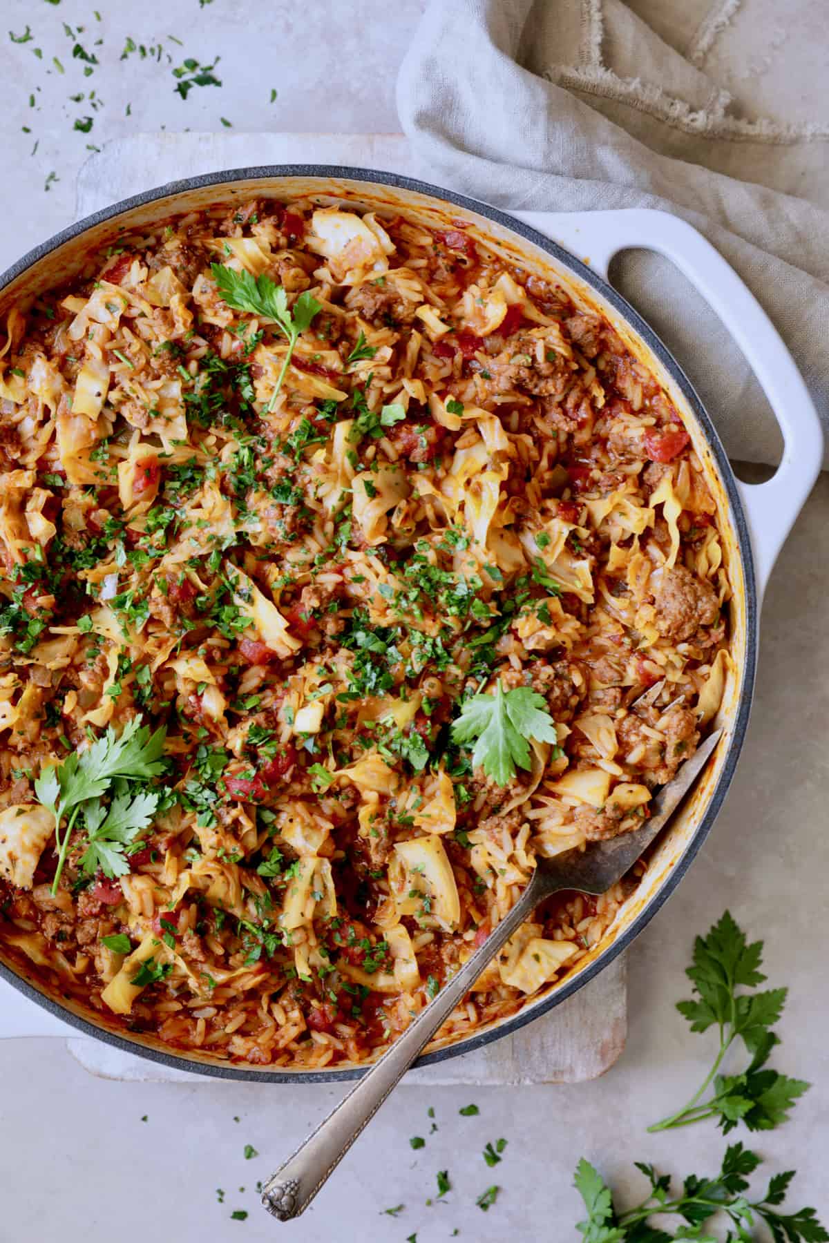 Photo of Unstuffed Chorizo Cabbage Roll Skillet on beige surface with beige napkin.