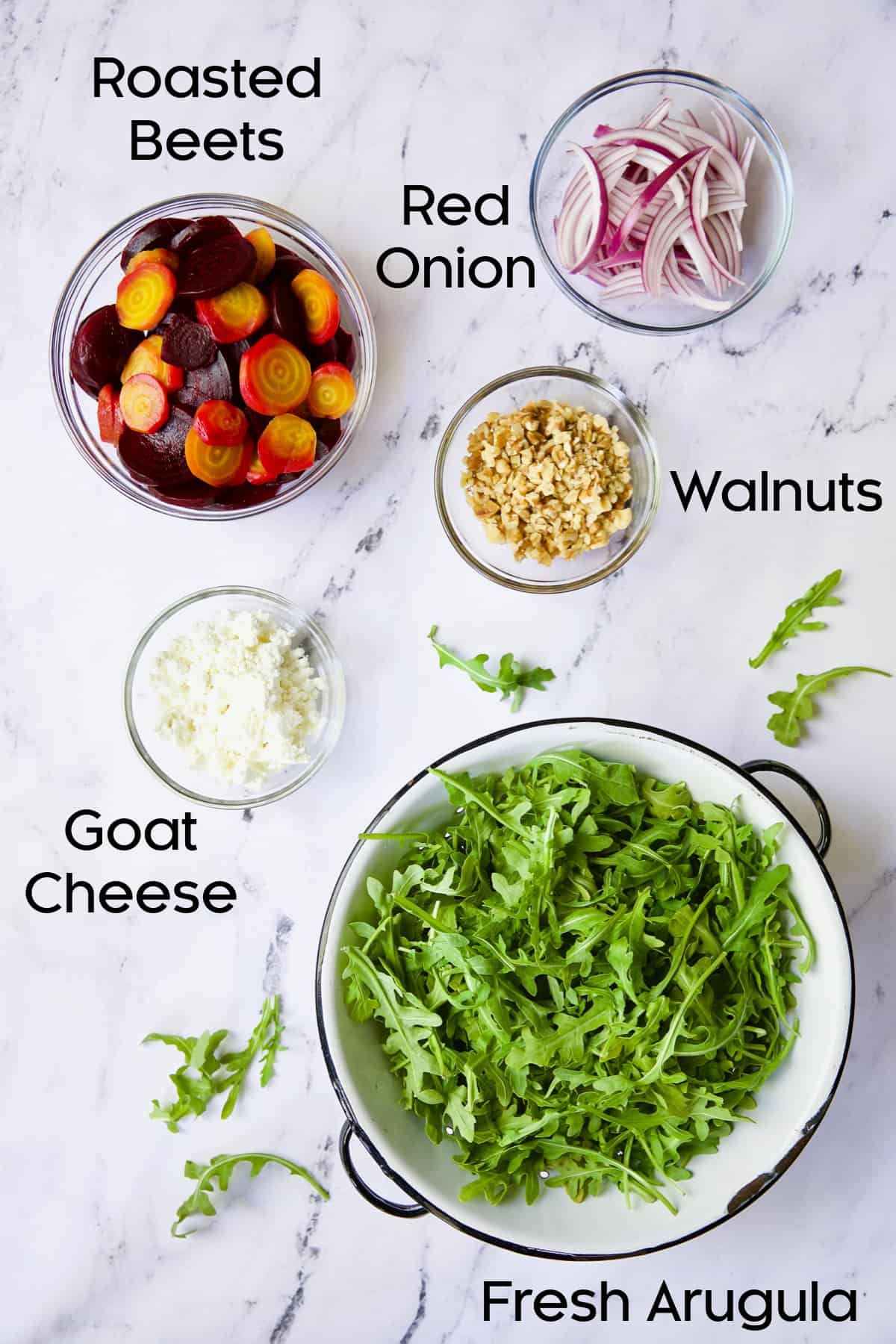 Photo of ingredients for Roasted Beet Salad with Walnuts Goat Cheese and Honey Balsamic Dressing in glass bowls.
