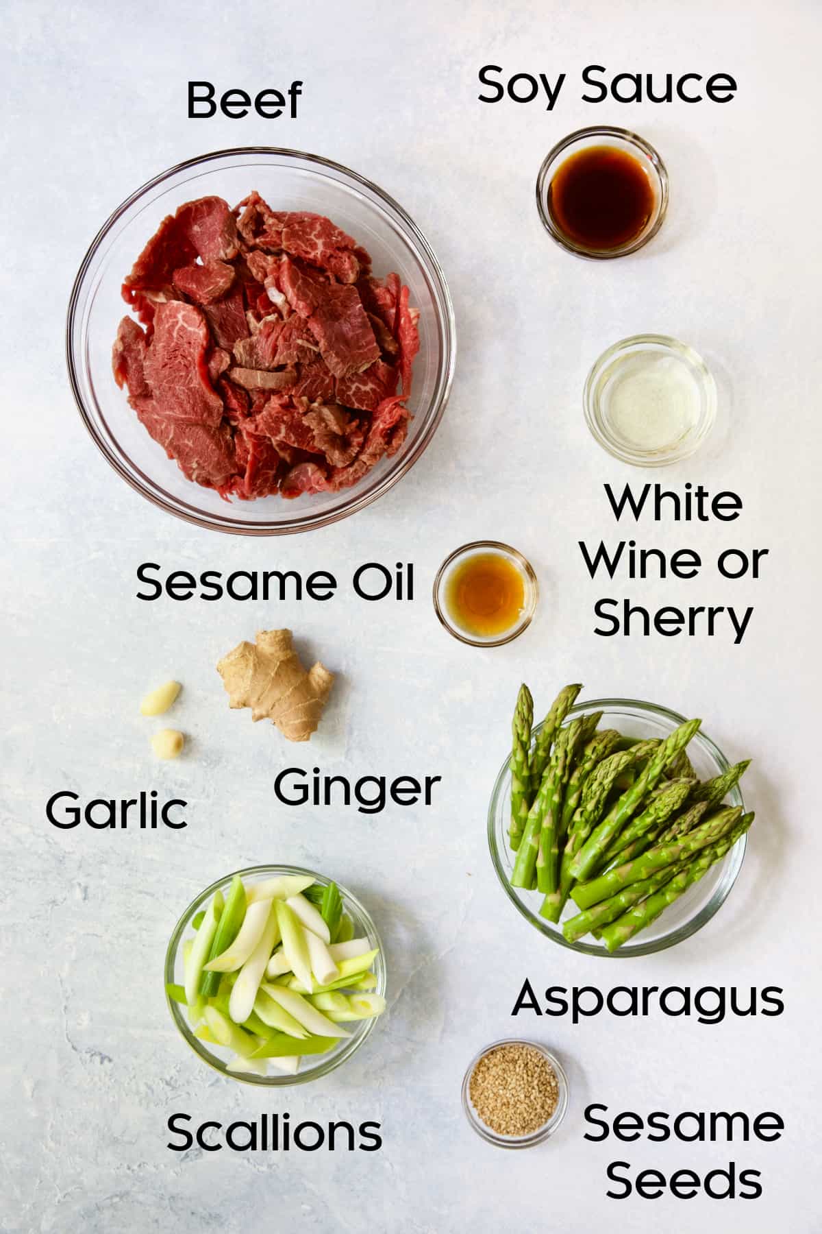 Photo of ingredients for Sesame Beef and Asparagus Stir-Fry in glass bowls.