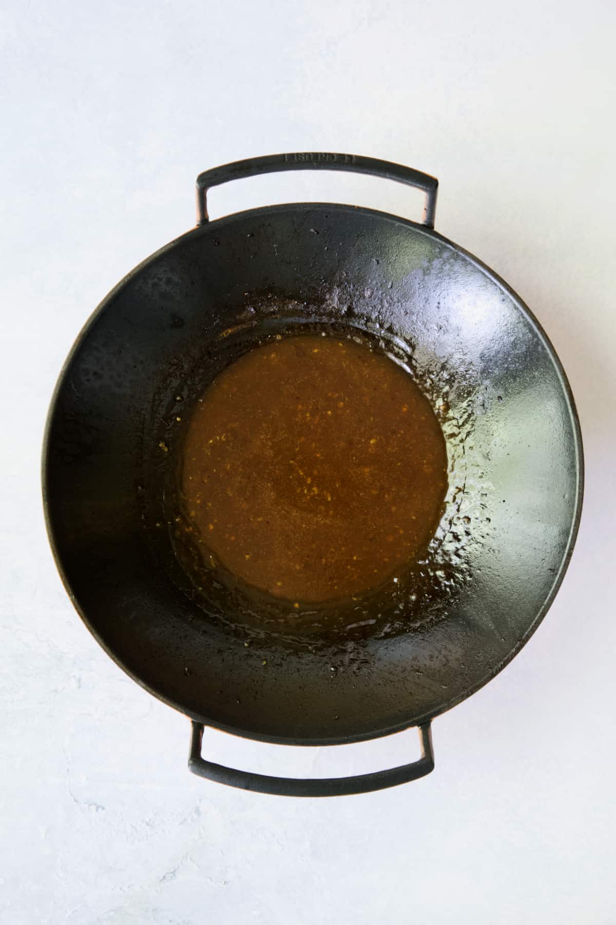 Sauce for Sesame Beef and Asparagus Stir-Fry in cast iron wok.