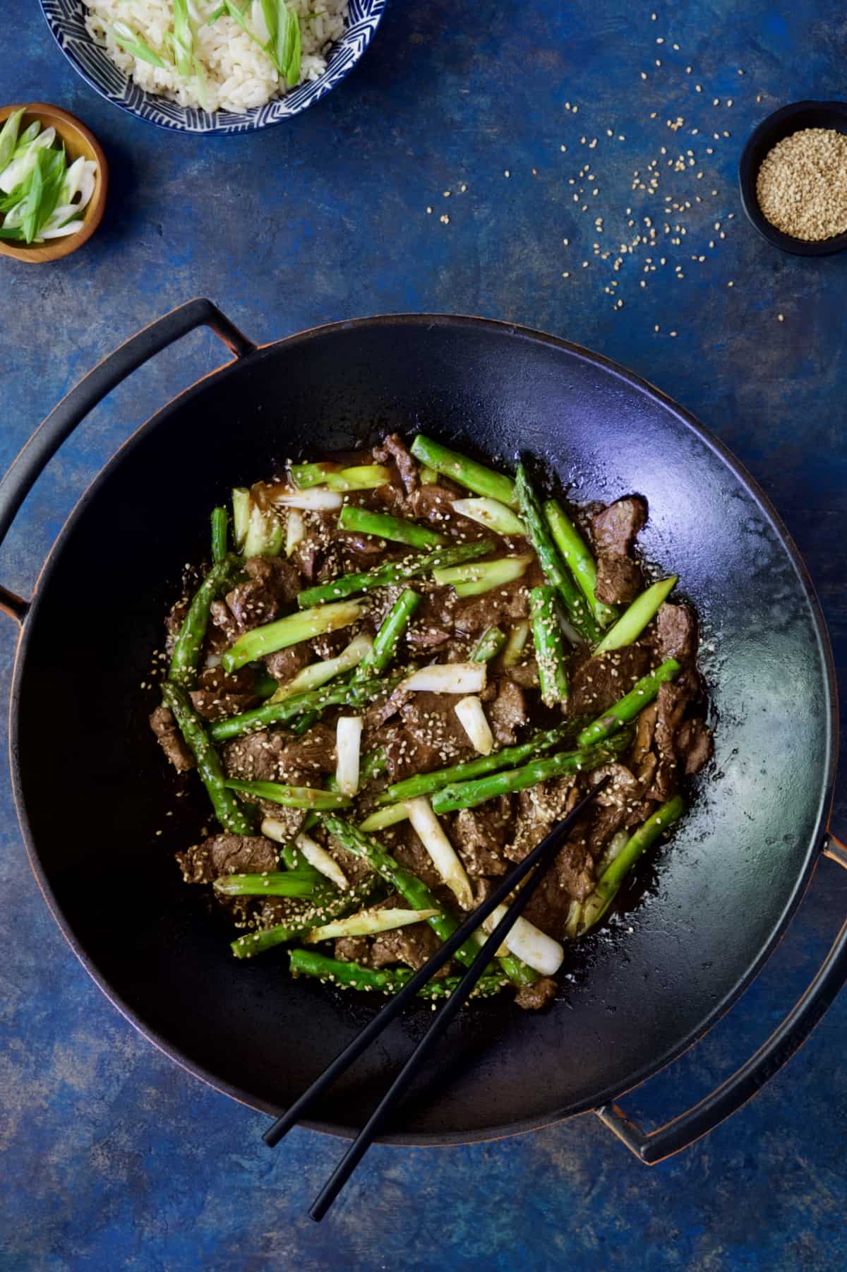 Sesame Beef and Asparagus Stir-Fry with black chopsticks.