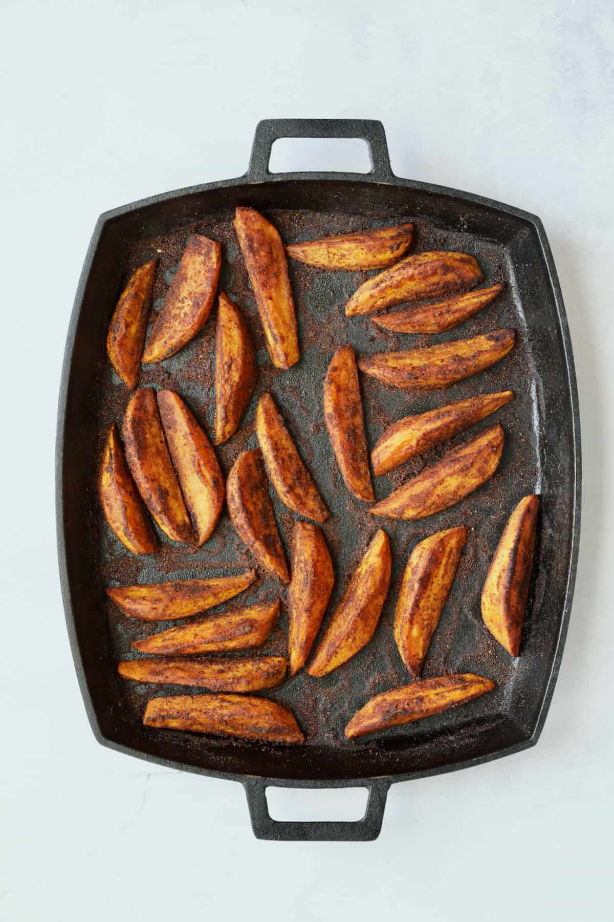 Southwestern Sweet Potato Wedges on cast iron pan after being roasted.