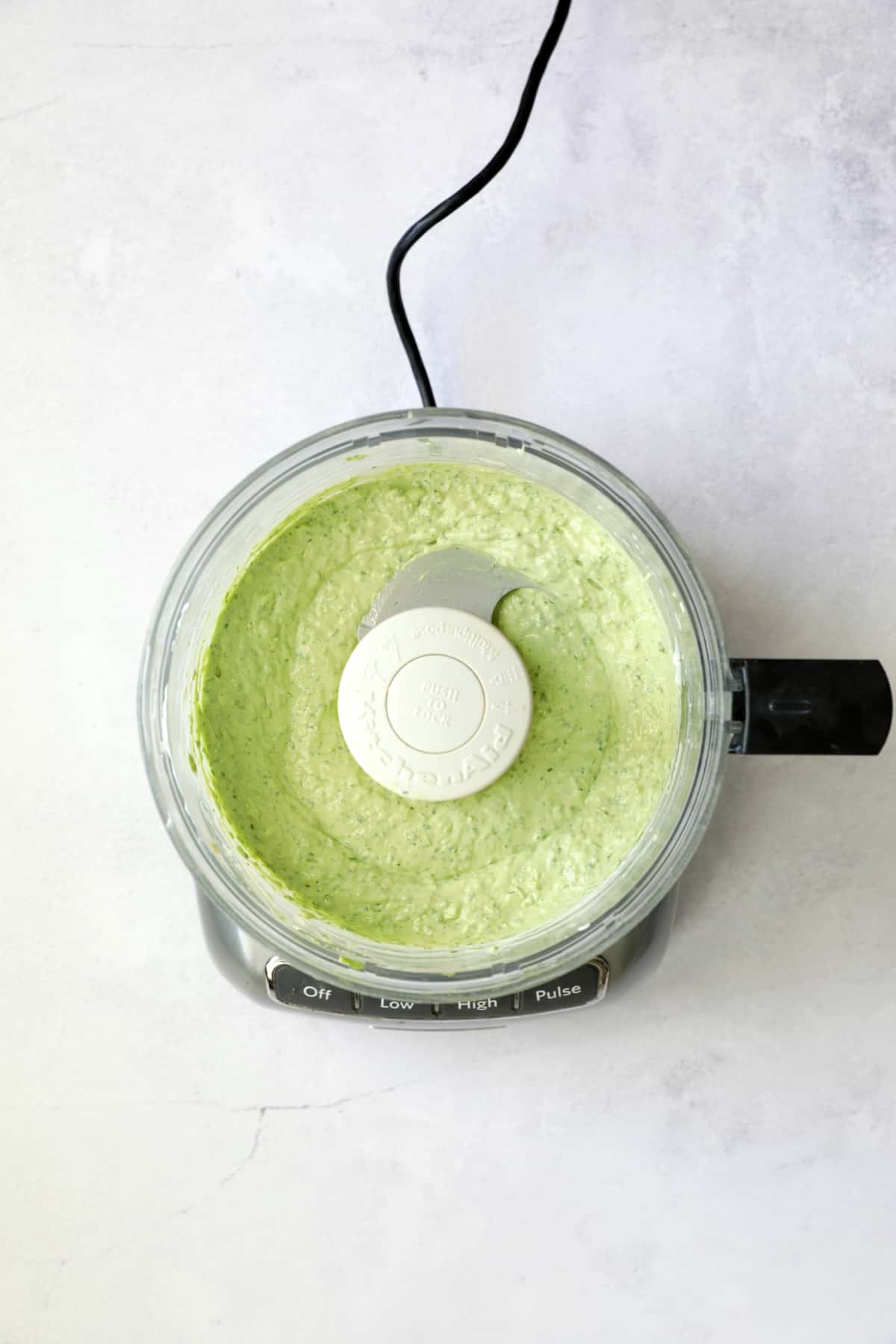 Avocado-Cilantro Sour Cream in food processor.