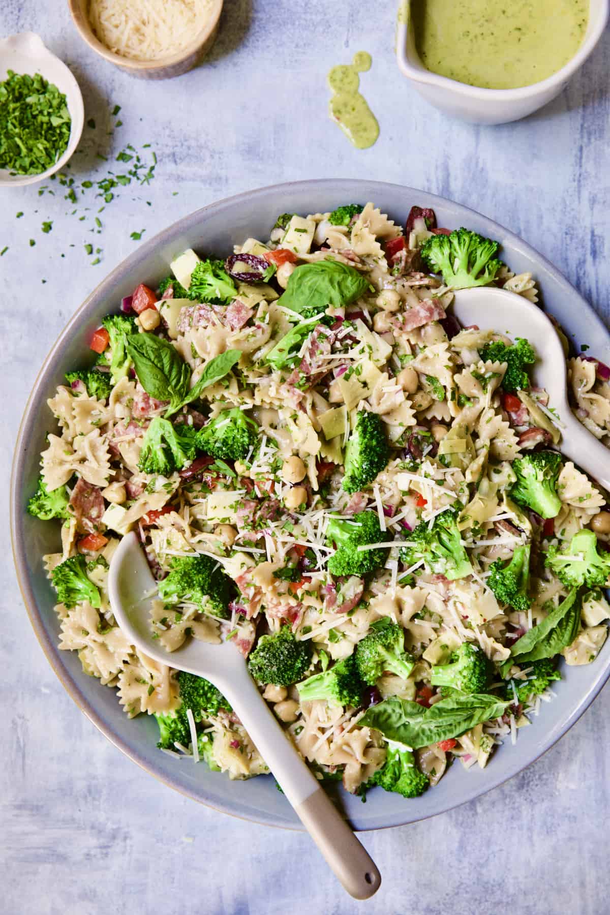Antipasto Pasta Salad with Parmesan Herb Vinaigrette in serving bowl.