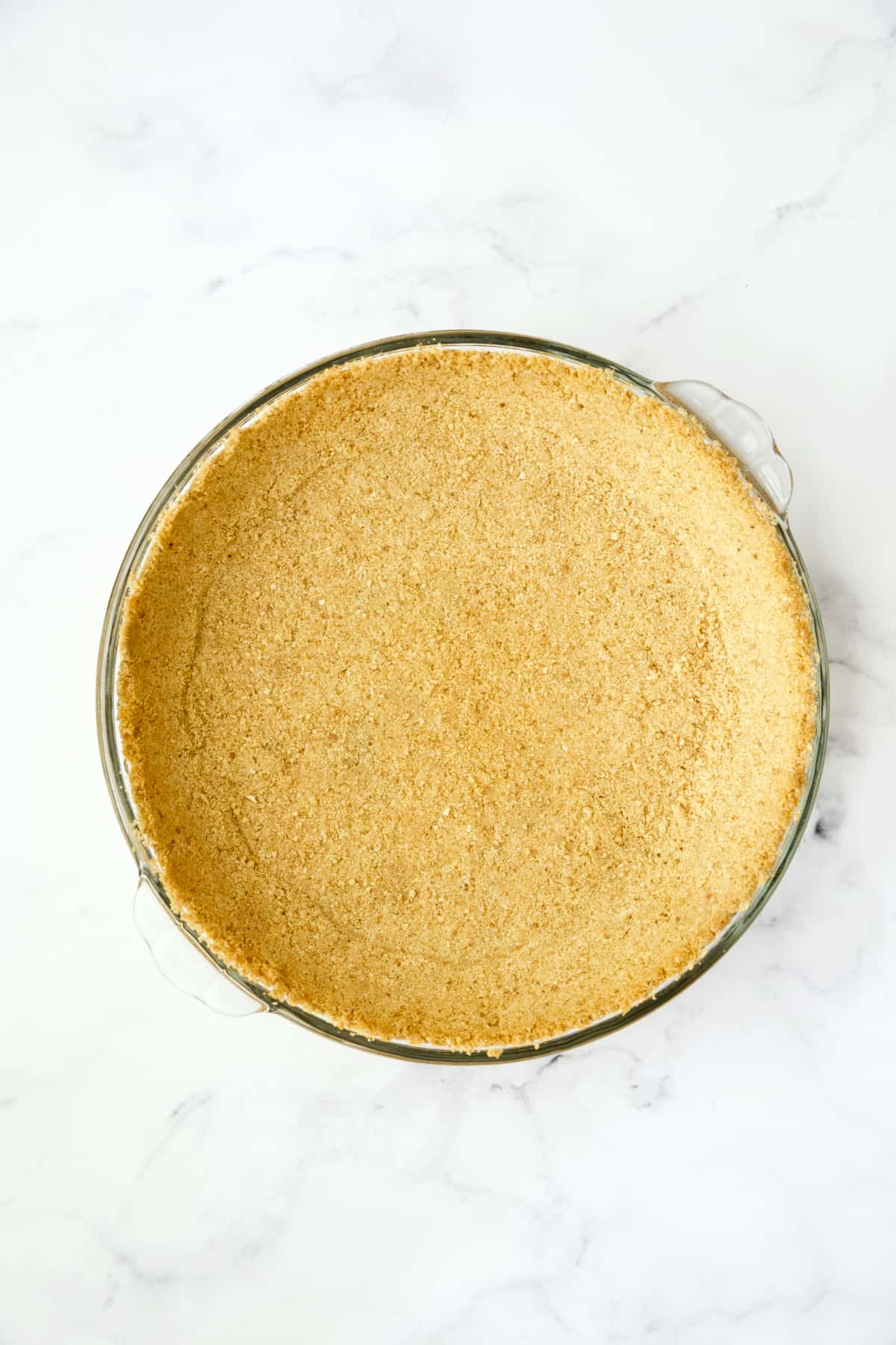 Process photo of unbaked graham cracker crust.