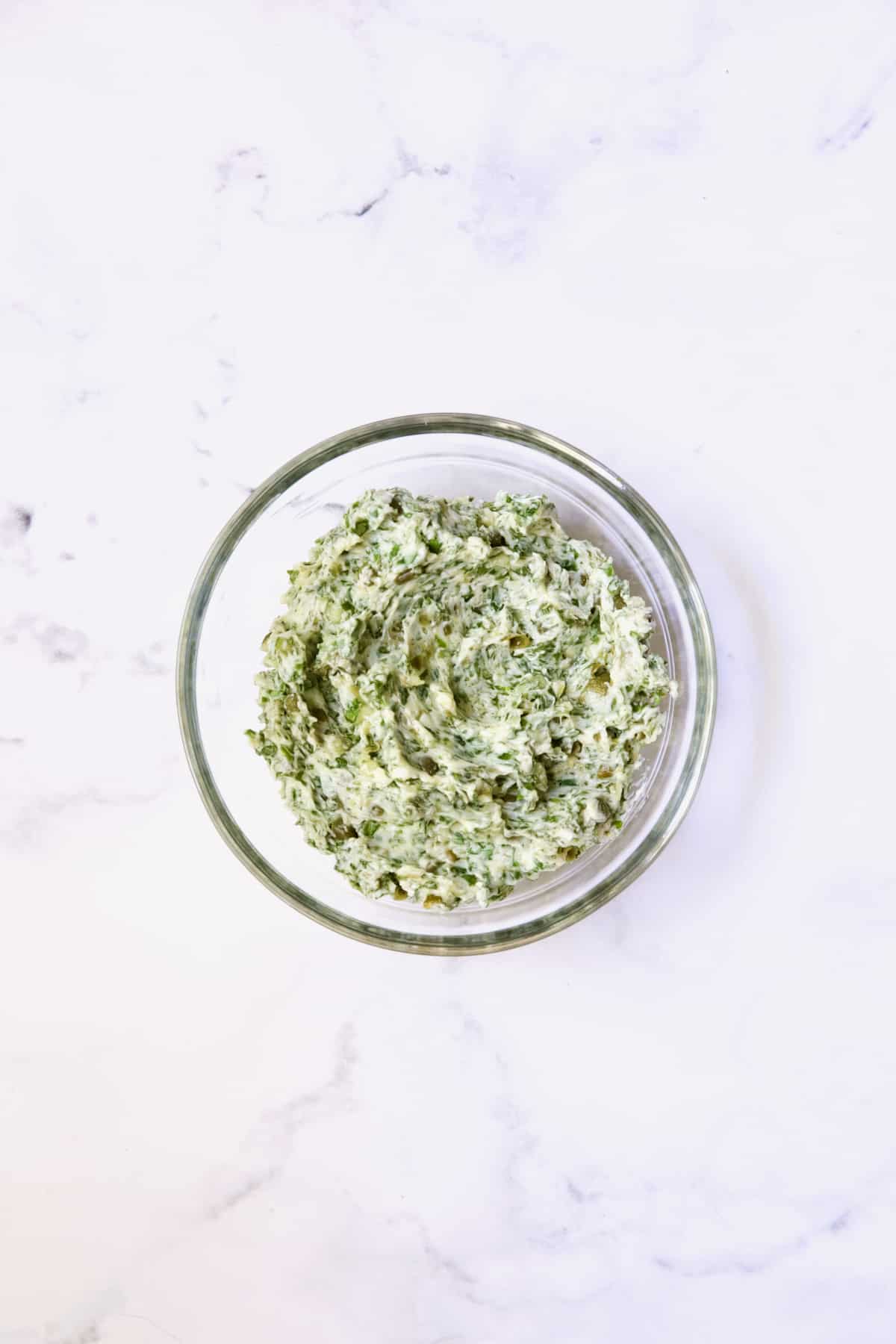 Herb - Caper Butter in glass bowl.