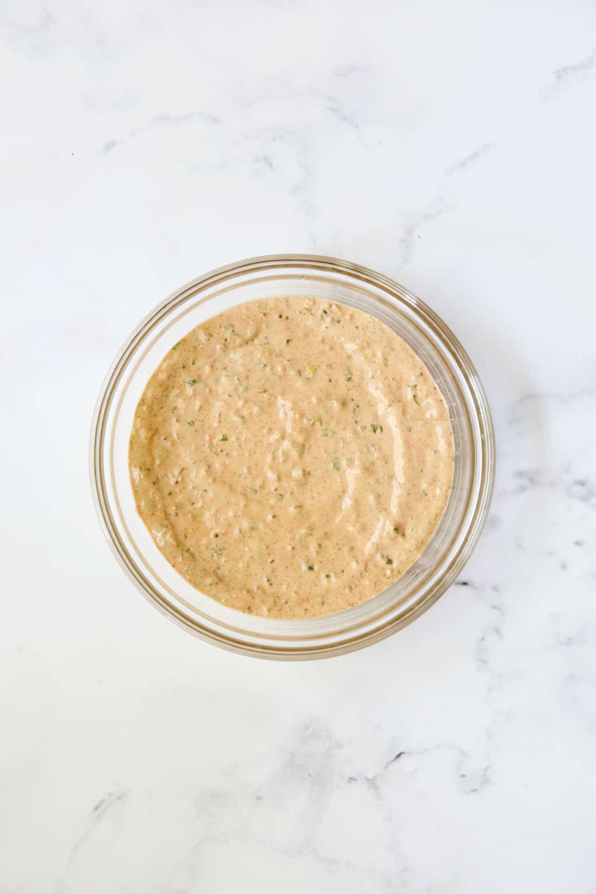 Sriracha remoulade in glass bowl.