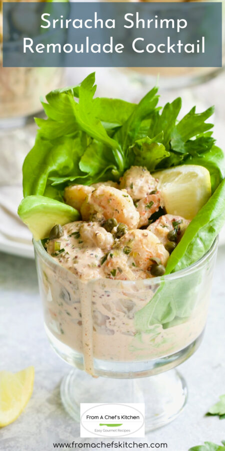 Pinterest graphic for Sriracha Shrimp Remoulade Cocktail showing it in a footed glass with lettuce, avocado and a lemon wedge.