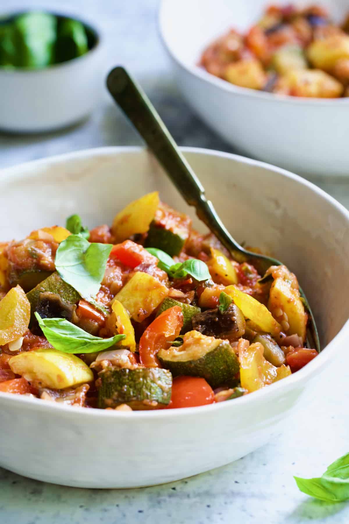 One serving of Classic French Ratatouille in white bowl with fork.