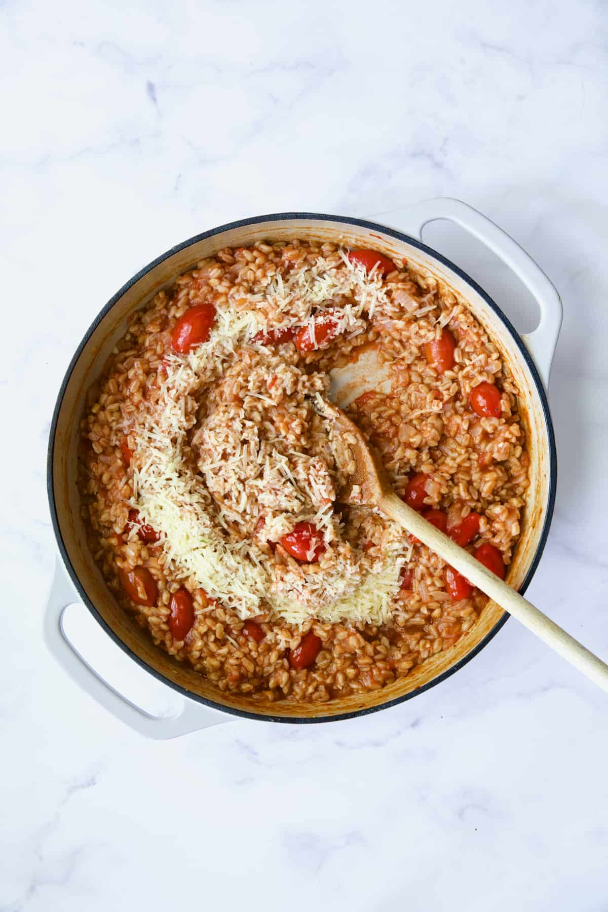 Process photo of farro risotto after Parmesan is added.