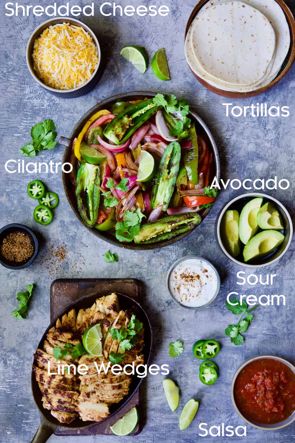 Ingredients for Grilled Tagin-Seasoned Chicken Fajitas on blue background.