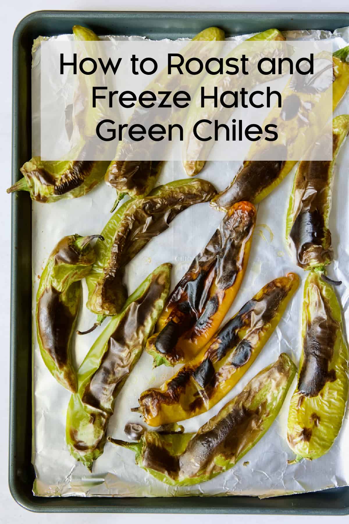 Hatch green chiles on aluminum-foil lined sheet pan with title of post.