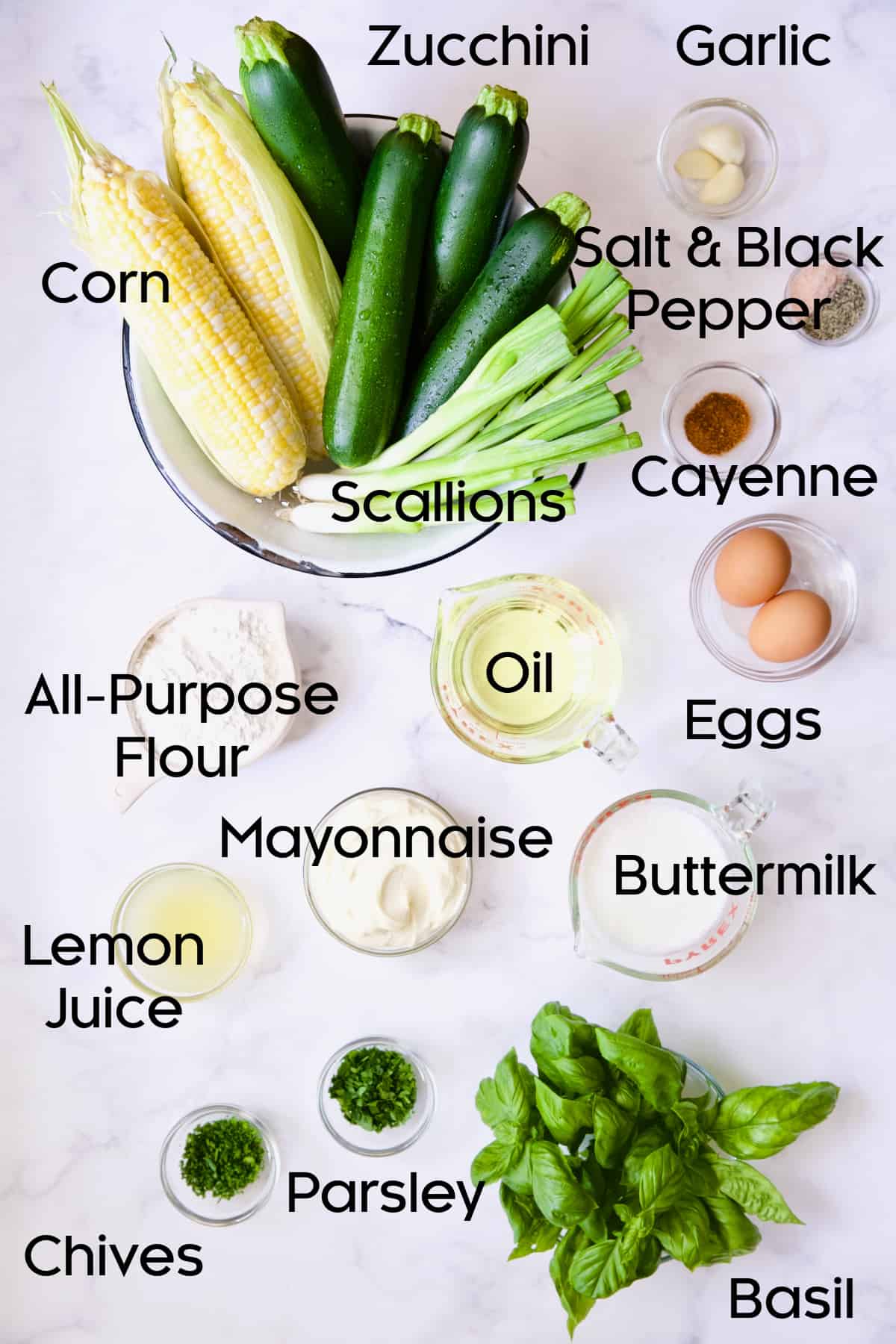 Ingredients for Zucchini Corn Fritters with Basil Buttermilk Sauce in glass bowls.
