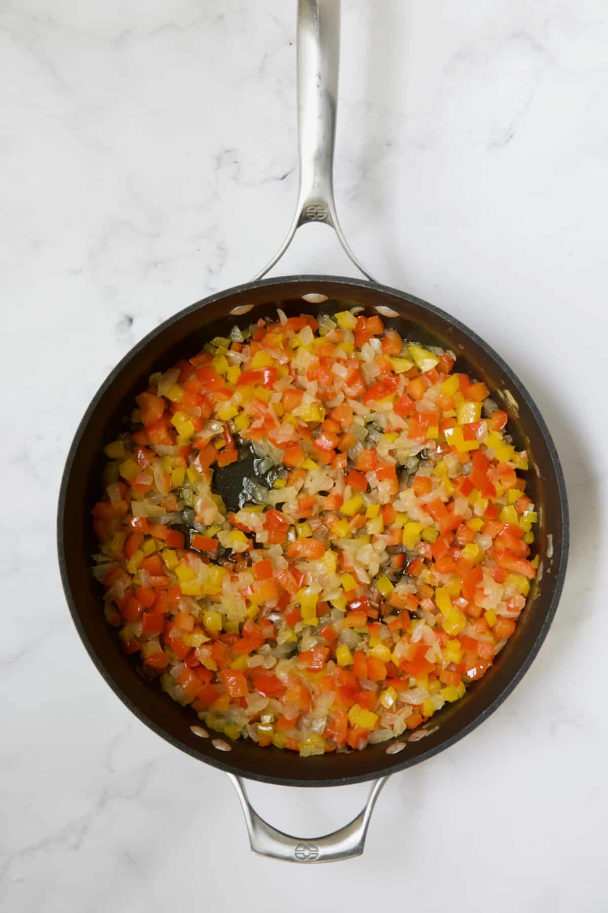 Cooked onions and peppers in skillet.