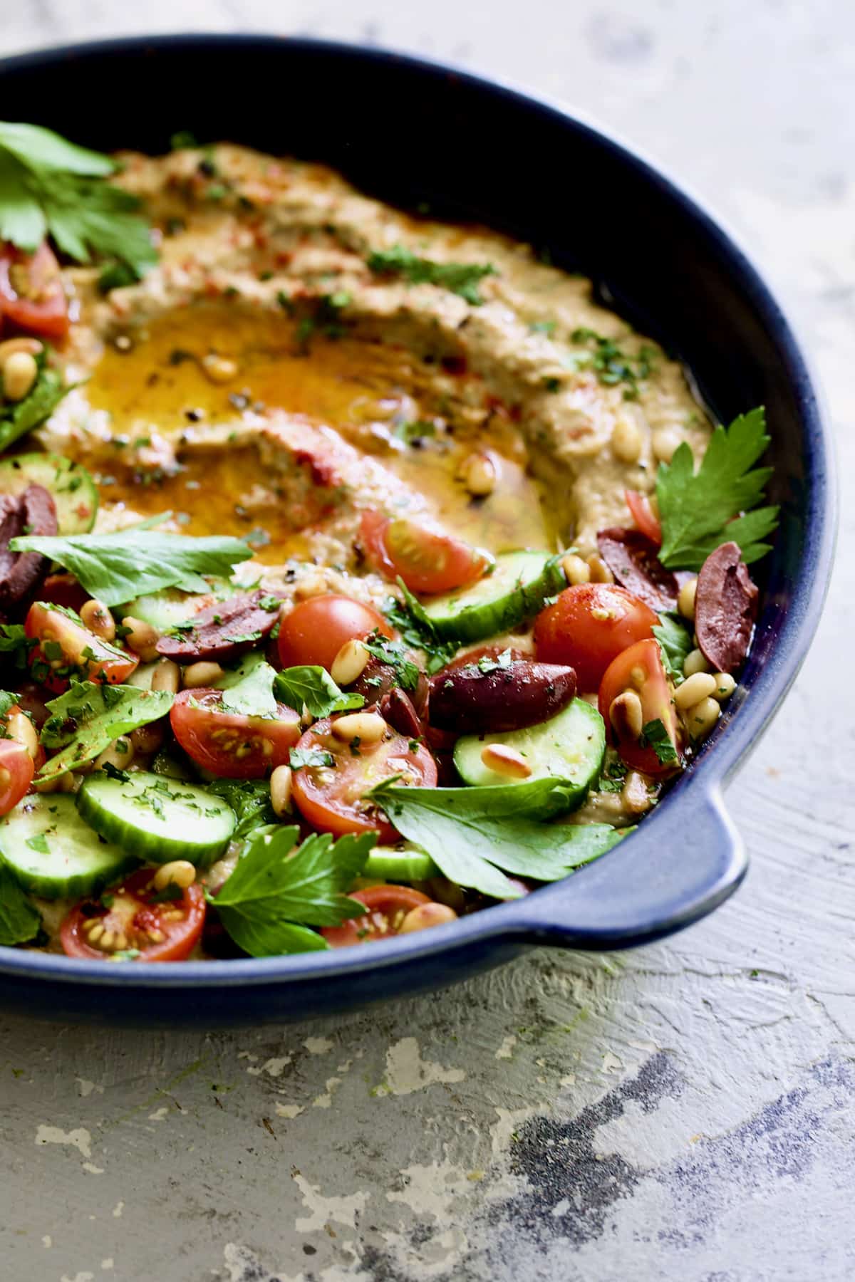 Loaded Roasted Eggplant Dip (Baba Ganoush) in blue dish.