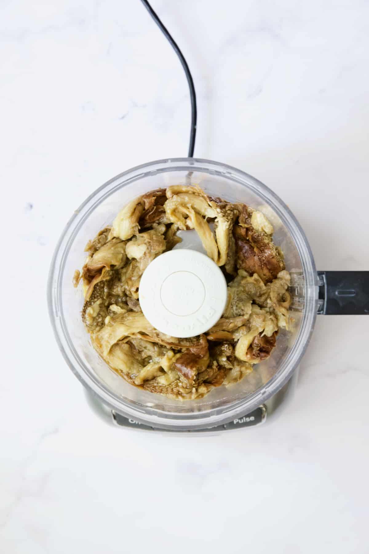 Eggplant in food processor before being pureed.