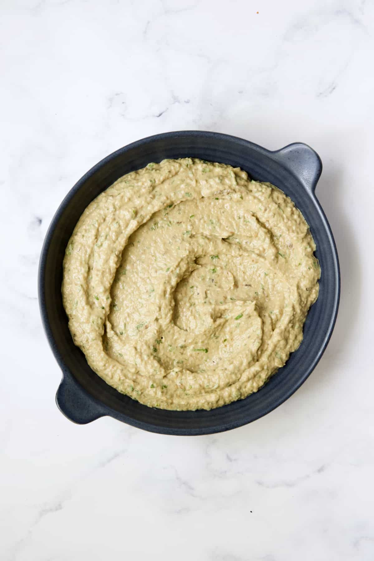 Eggplant Dip in blue dish without toppings.
