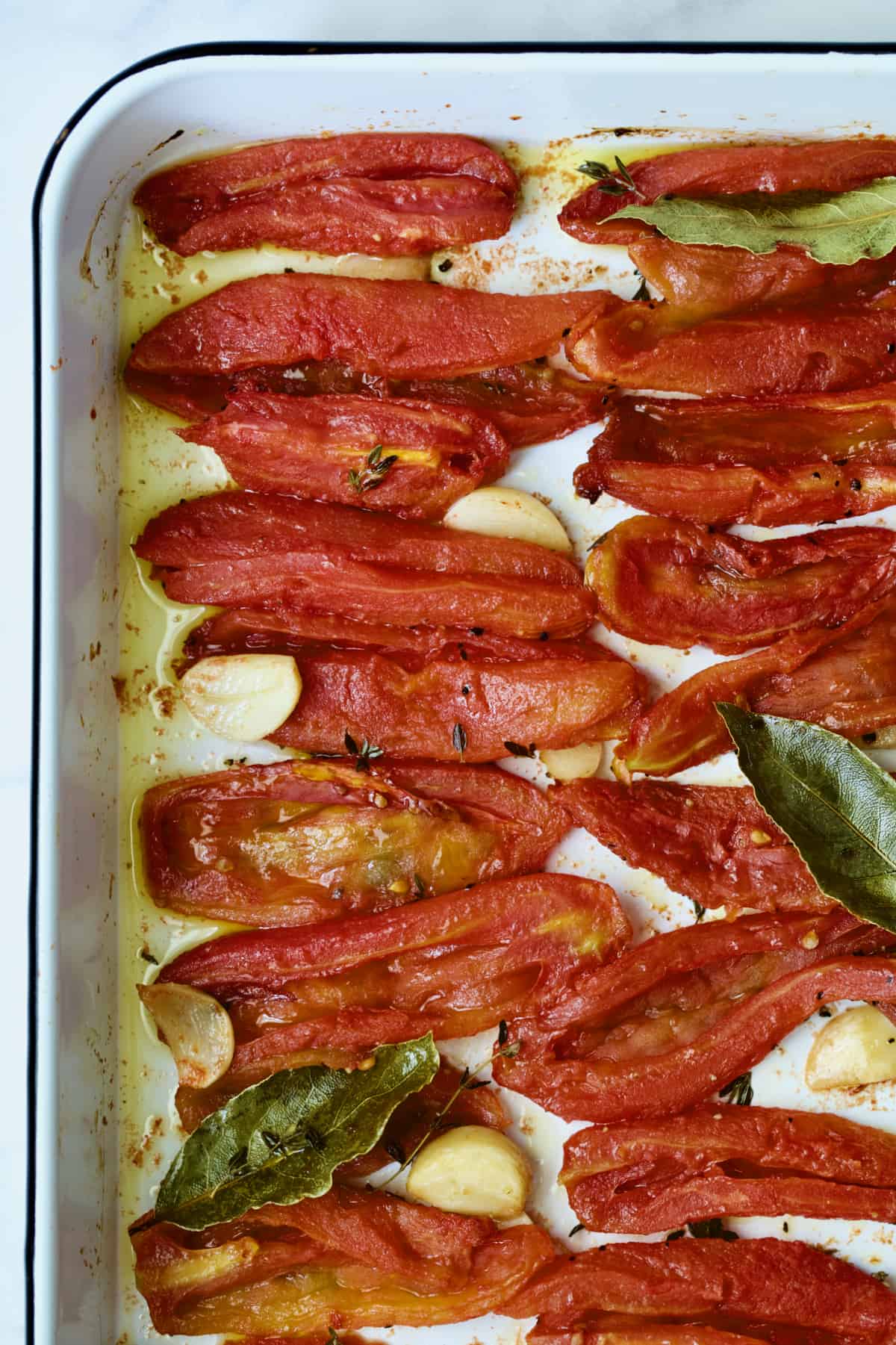 Tomato Confit on white enameled baking sheet.