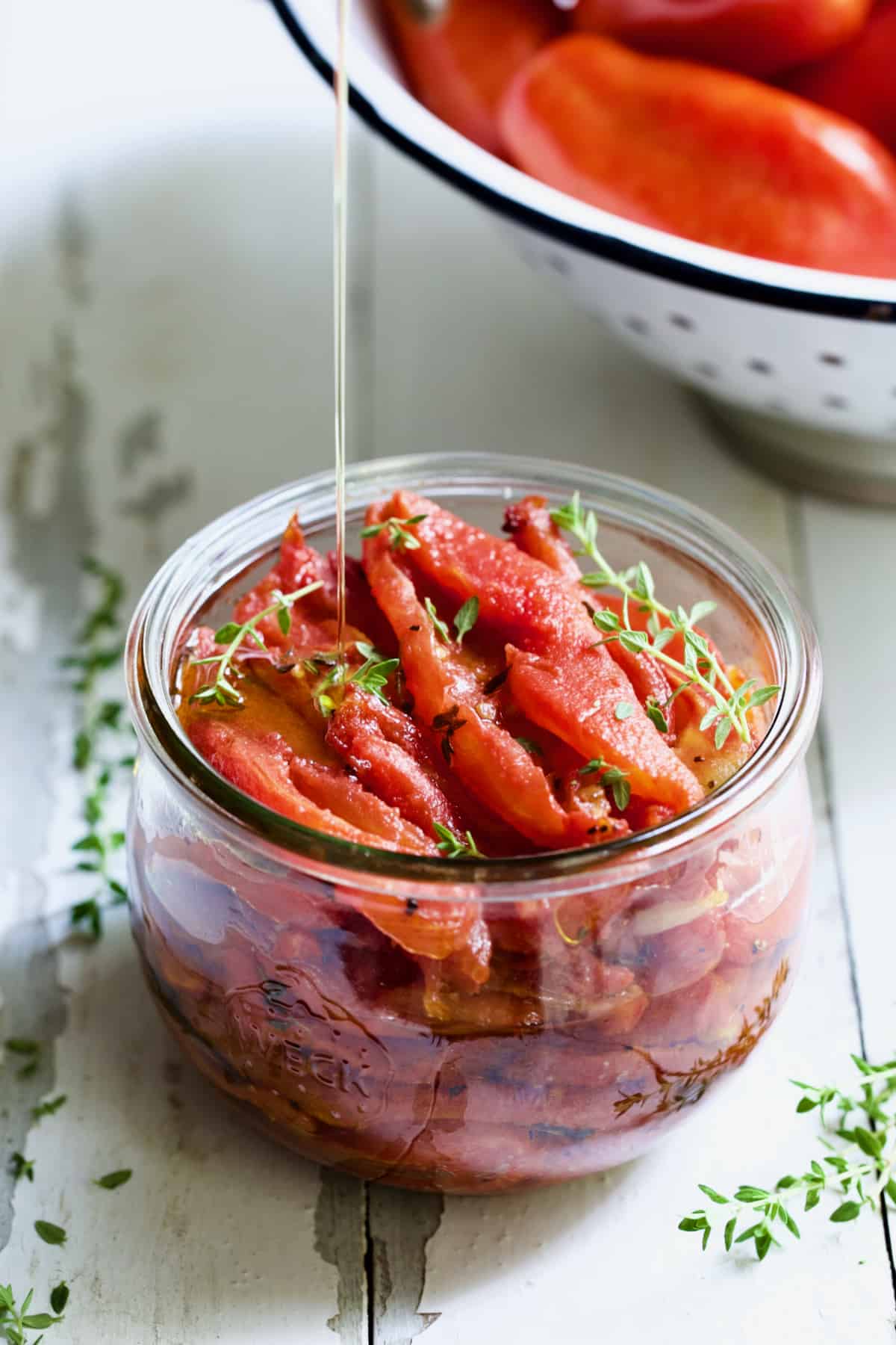 Tomato Confit being drizzled with olive oil.