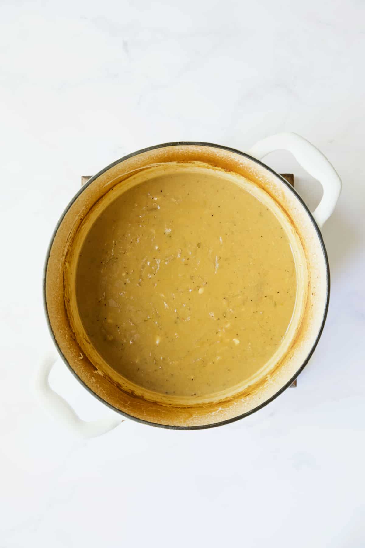 Dijon mustard sauce in white Dutch oven.
