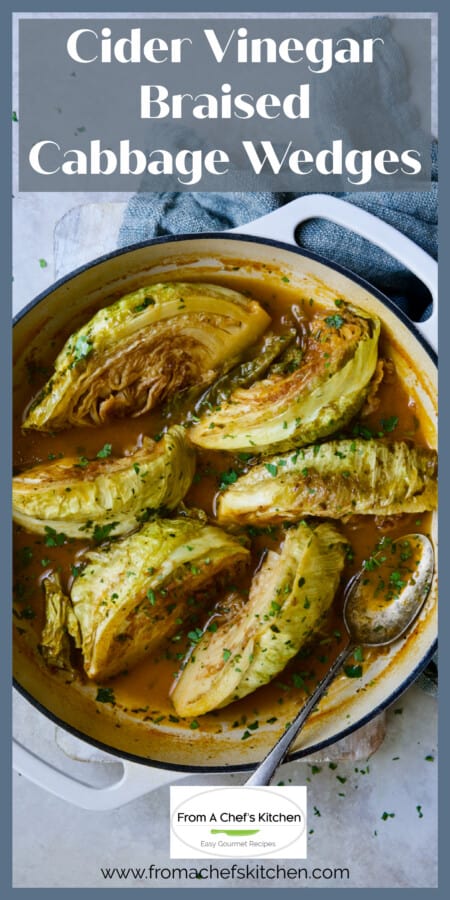 Six braised cabbage wedges in white enamel cast iron skillet.