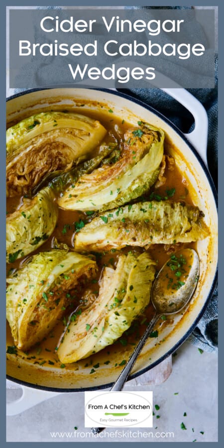Six braised cabbage wedges in white enamel cast iron skillet.