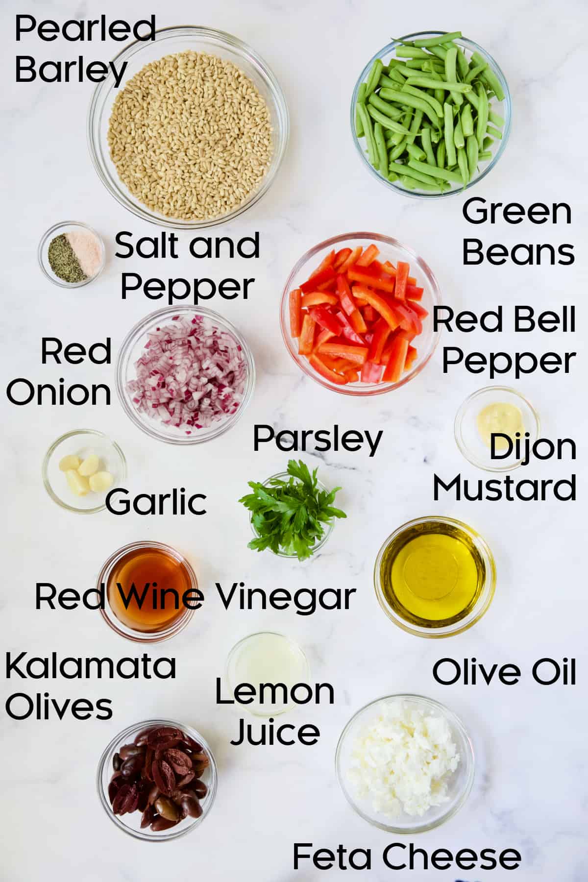 Ingredients for Mediterranean Barley Salad in glass bowls.