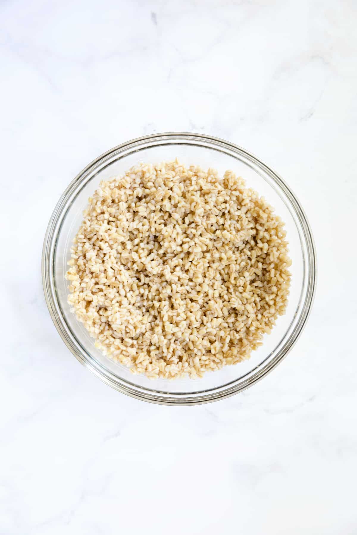 Cooked barley in glass bowl.