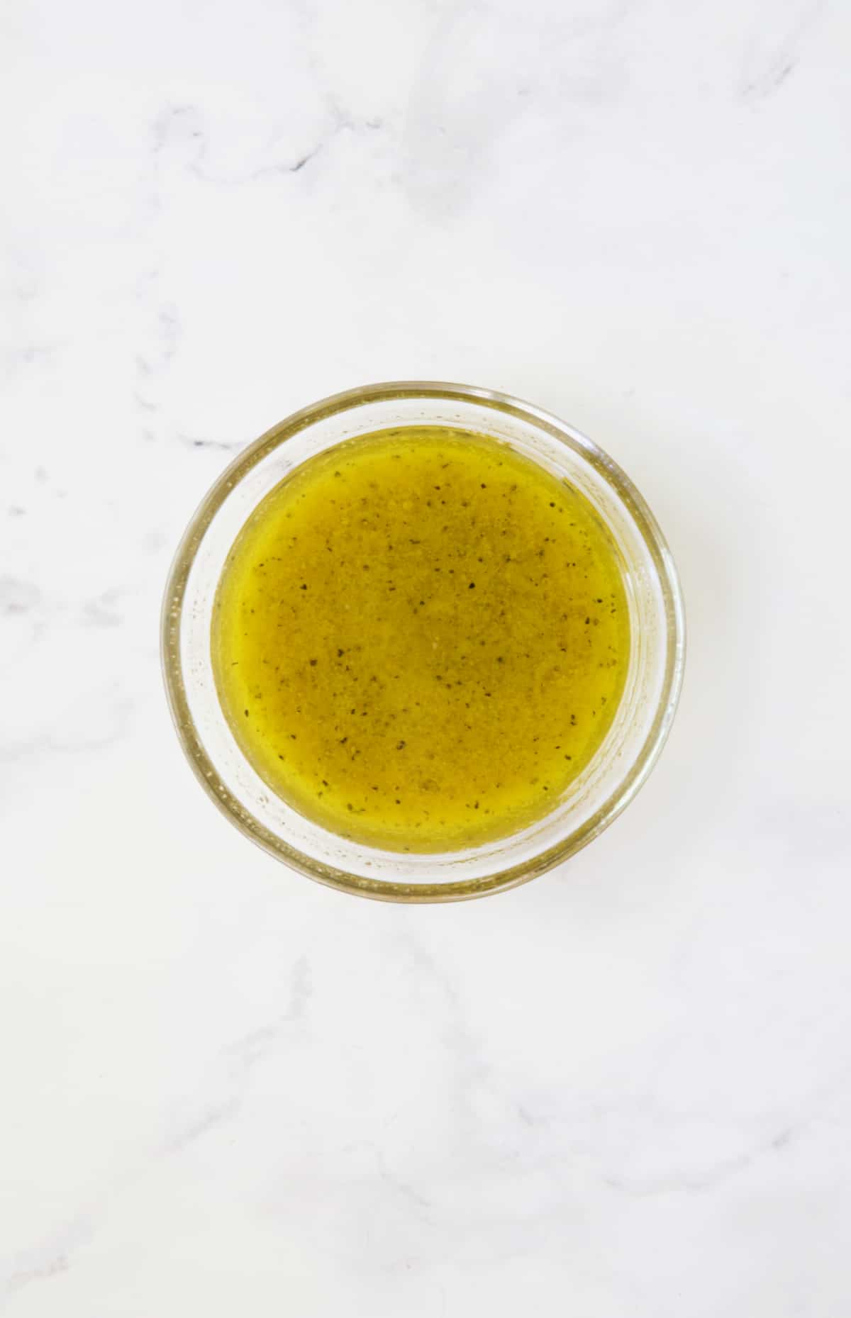 Dressing for Mediterranean Barley Salad in glass bowl.