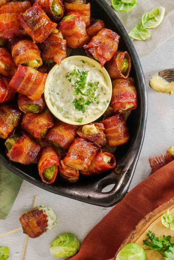 Balsamic Bacon-Wrapped Brussels Sprouts in black serving dish.