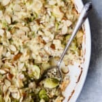 Cheesy Brussels Sprouts and Wild Rice Casserole in oval gratin dish with serving removed.