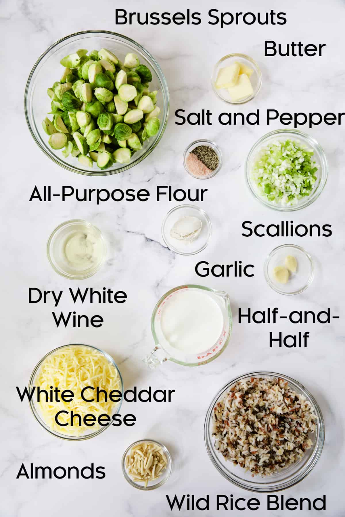 Ingredients for Cheesy Brussels Sprouts and Wild Rice Casserole in glass bowls.