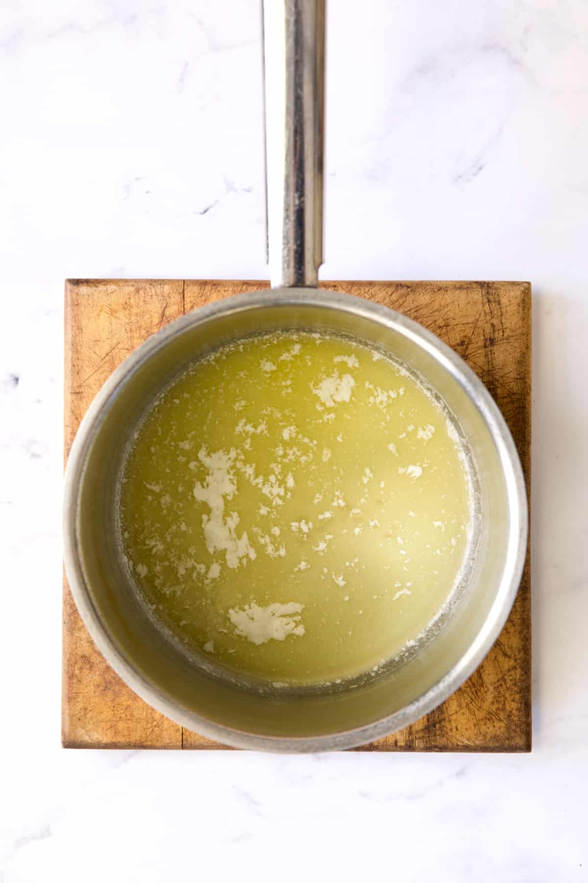 Melted butter in stainless steel saucepan.