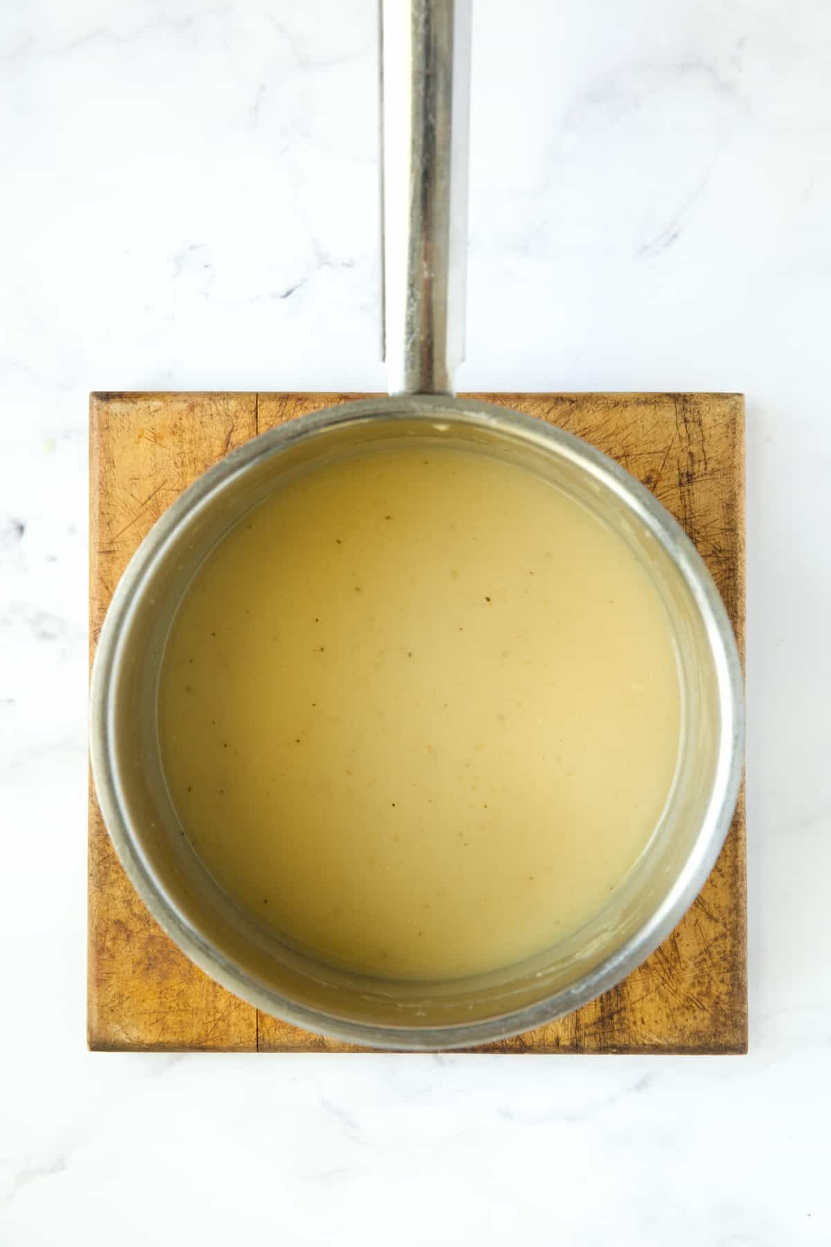 Gravy in stainless steel saucepan.