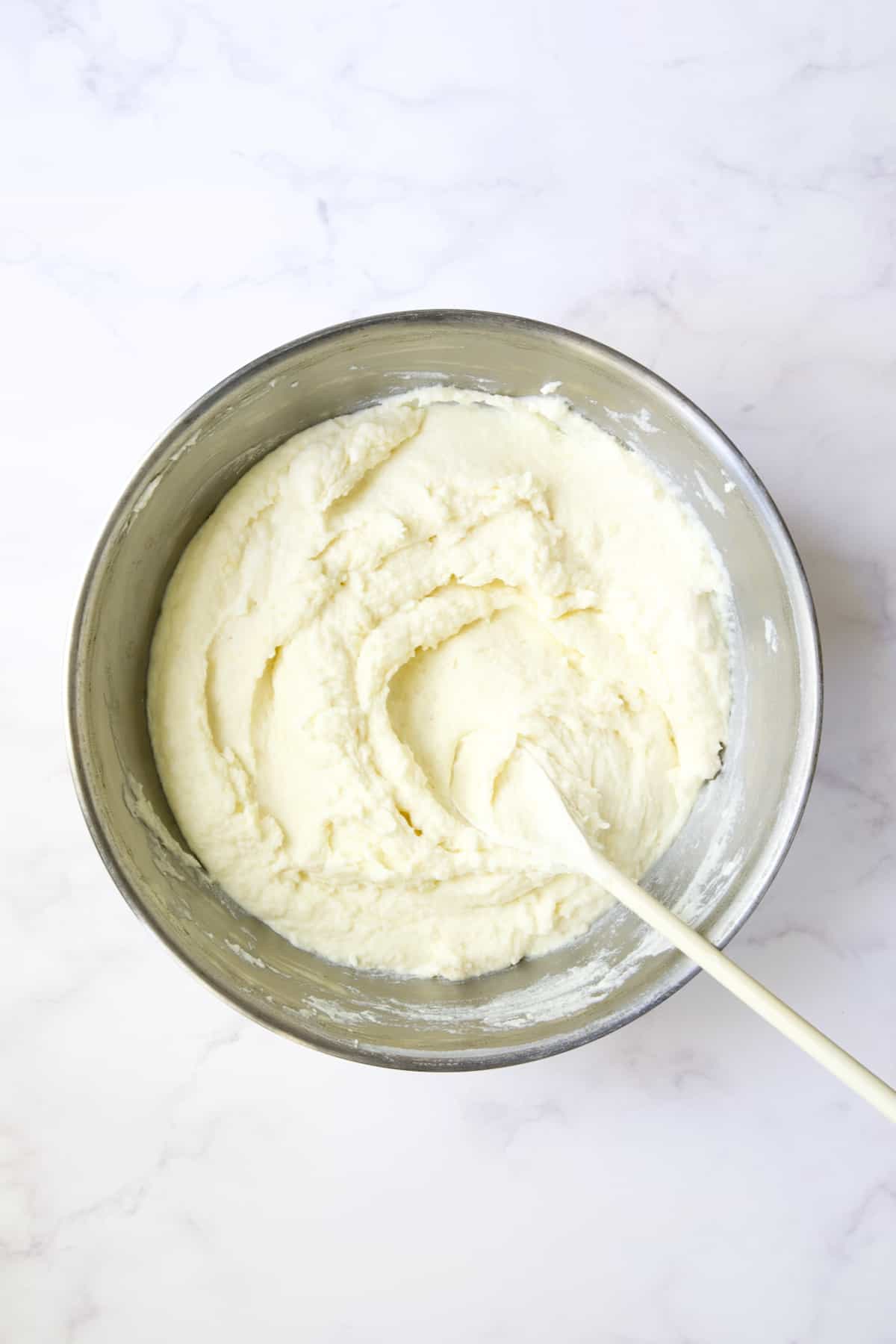 Mashed potatoes in stainless steel bowl.