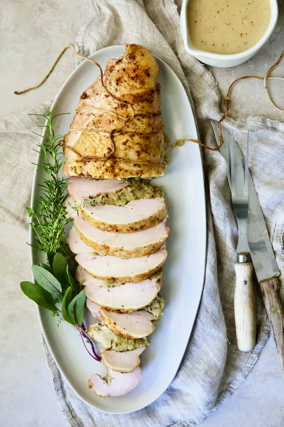 Roast Turkey Breast with Traditional Stuffing on white oval platter.