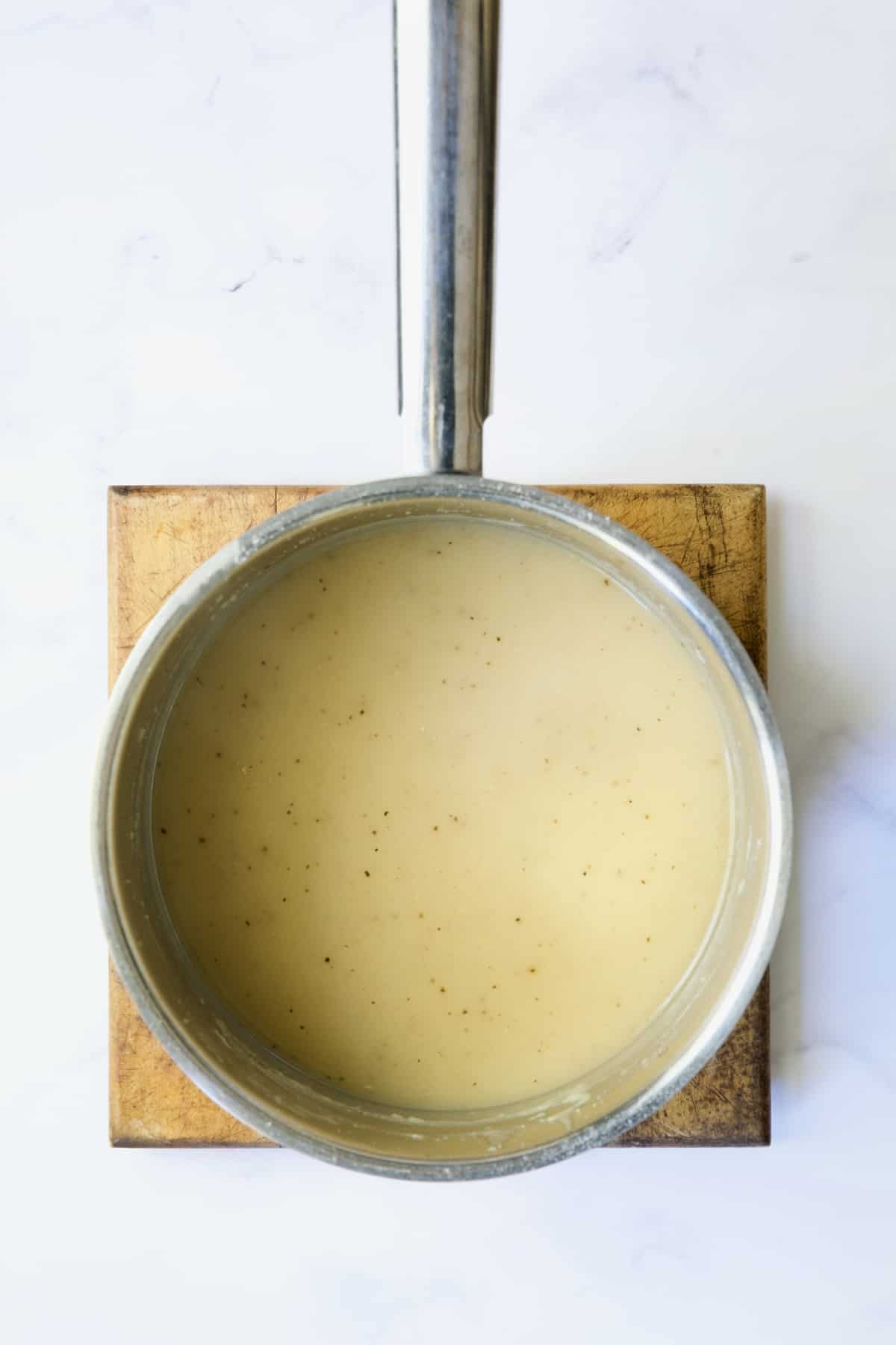 Turkey gravy in stainless steel saucepan.