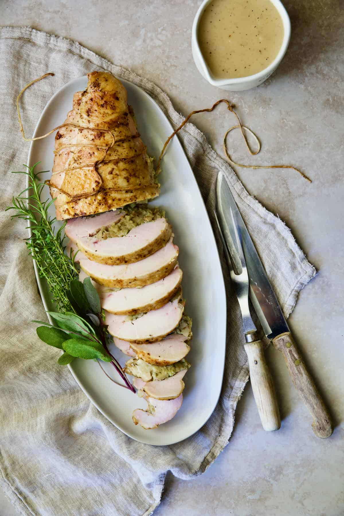 Roast Turkey Breast with Traditional Stuffing on white oval platter.