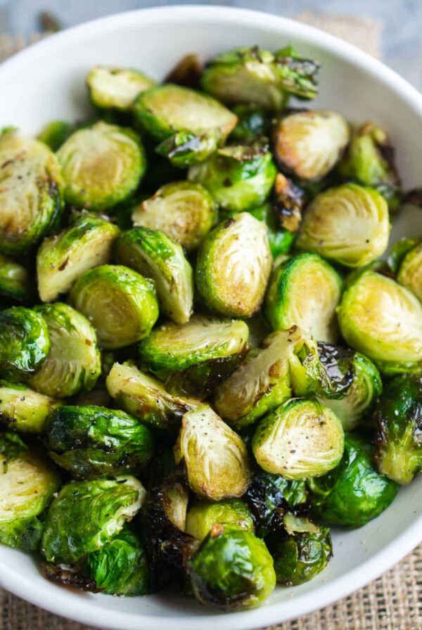 Air Fryer Brussels Sprouts in round white serving bowl.
