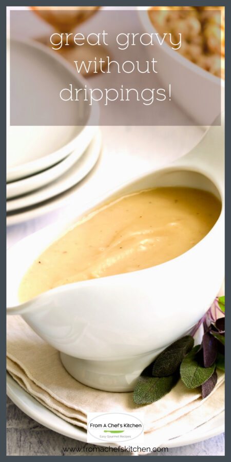Chicken gravy in white gravy boat garnished with sage leaves.