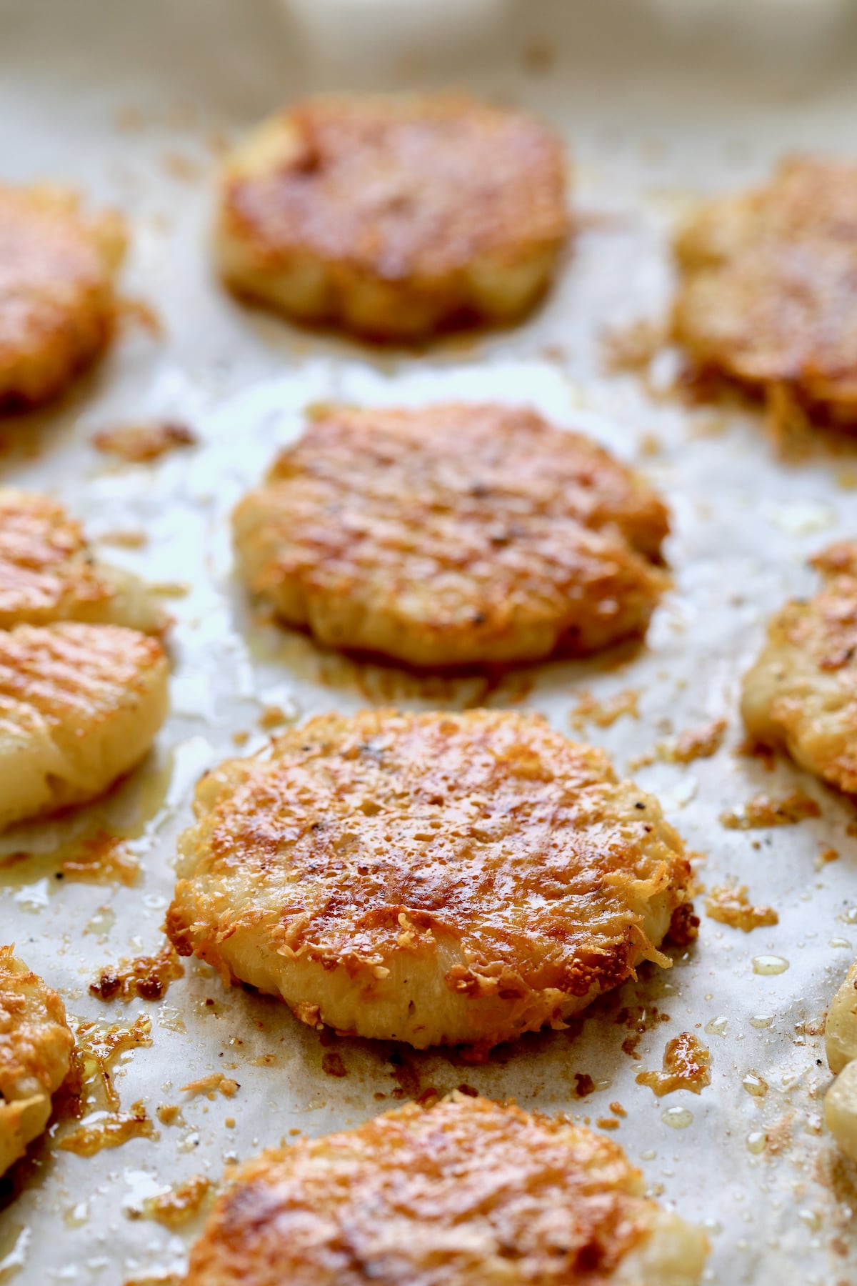 Parmesan Crusted Crushed Turnips on parchment paper.
