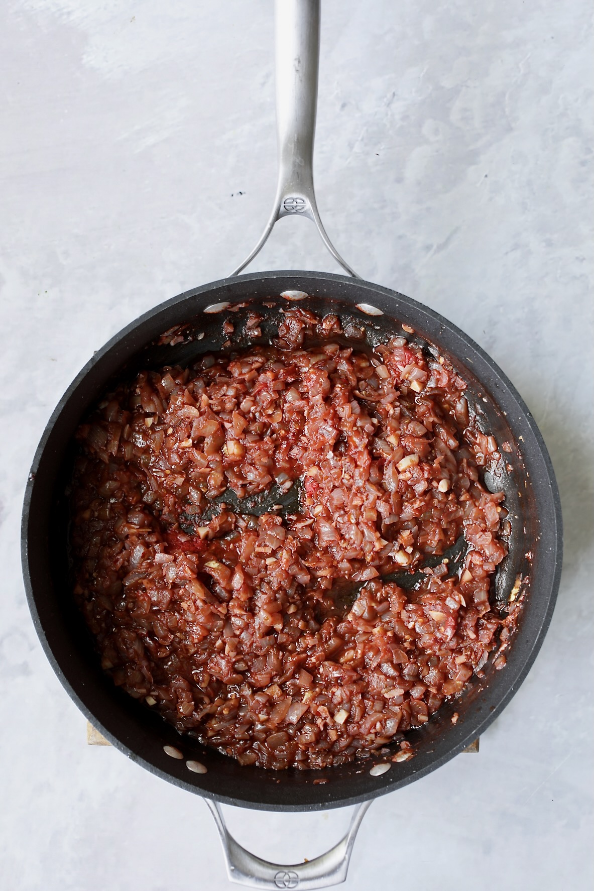 Onions in skillet with red wine that has been reduced.