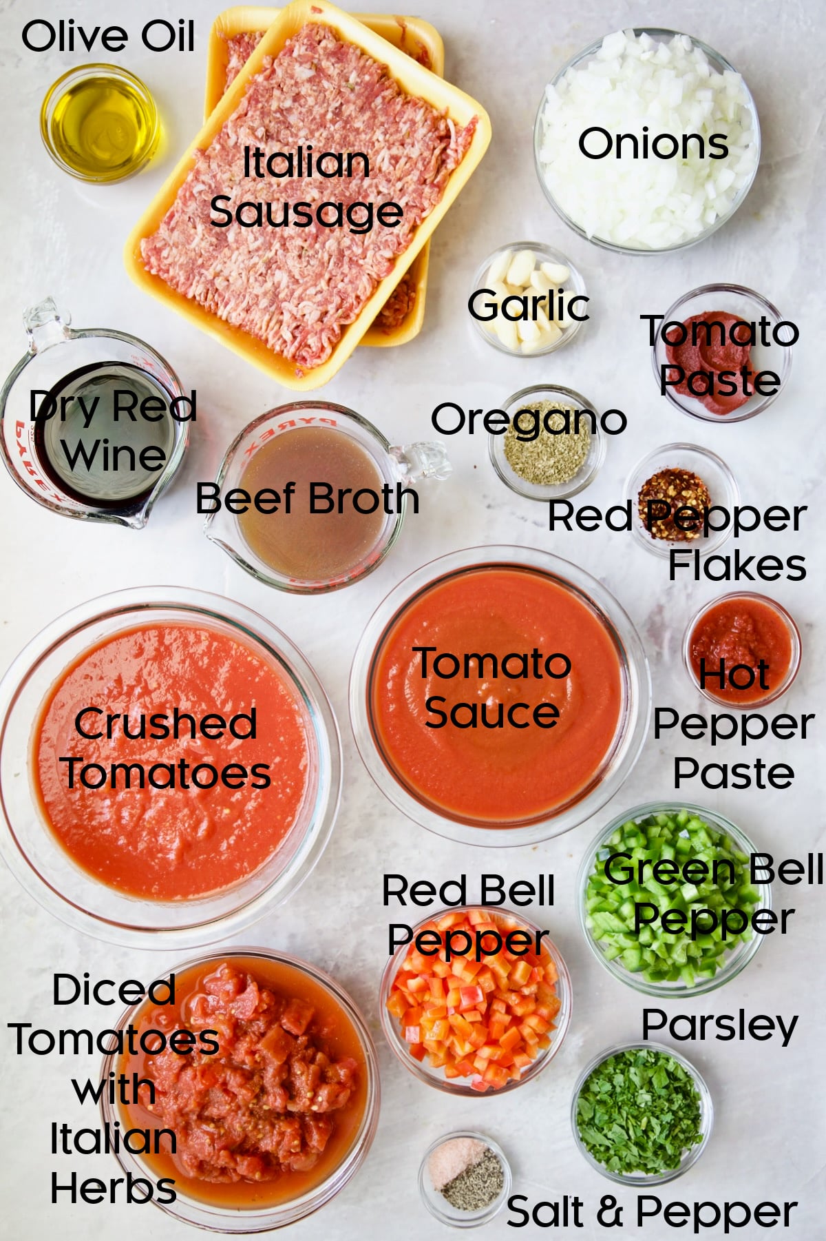 Ingredients for Slow Cooker Spicy Sausage and Pepper Ragu in glass bowls.