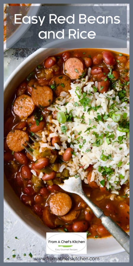One serving of Easy Red Beans and Rice garnished with fresh parsley and scallion in white bowl with fork.